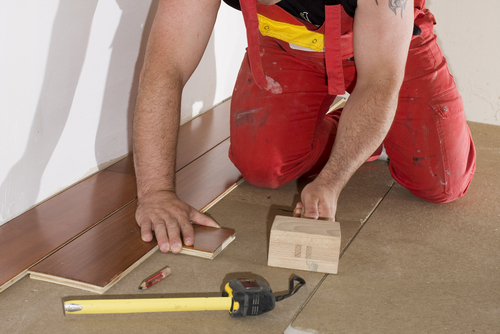 worker installs a hardwood floor